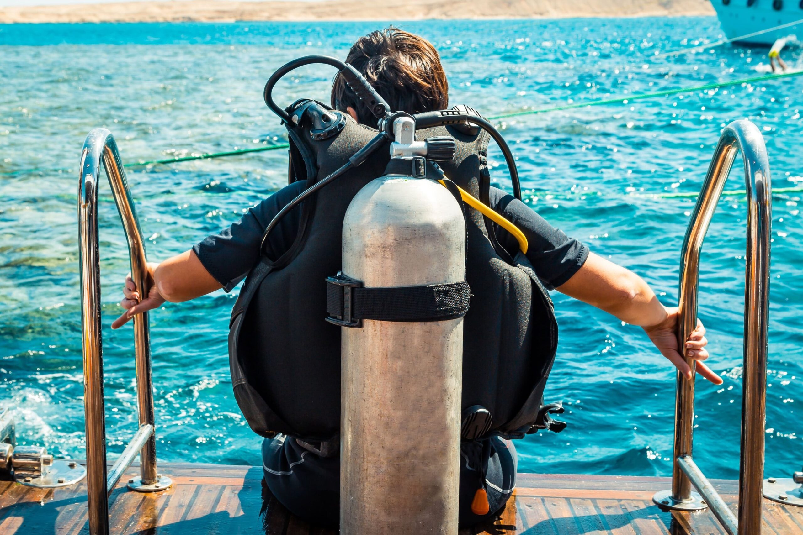 a man in a diving suit is standing on a boat
