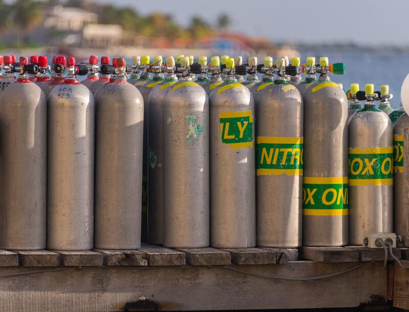 a bunch of gas bottles of gas on a trailer